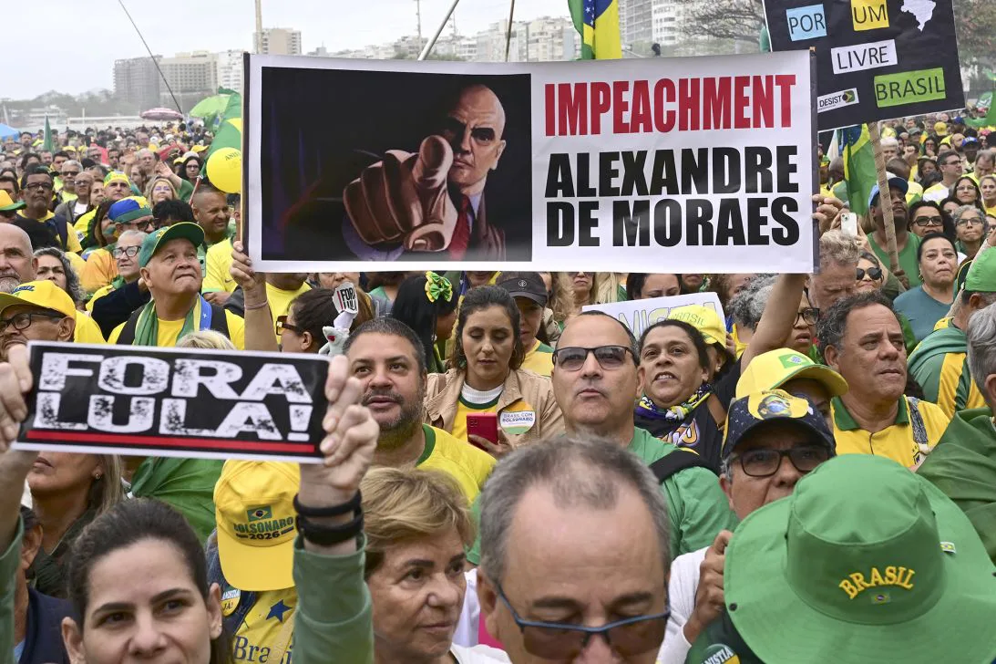 Supporters of Brazil's former president Jair Bolsonaro hold a banner demanding the impeachment of Supreme Federal Court judge Alexandre de Moraes at Copacabana beach in Rio de Janeiro, Brazil on September 7, 2025.